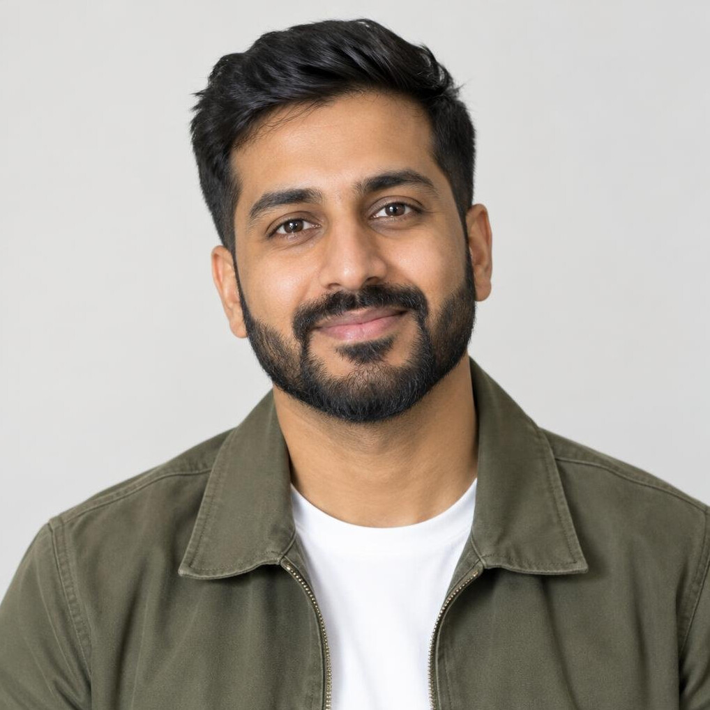 Portrait of a South Asian British man with a beard wearing a casual jacket