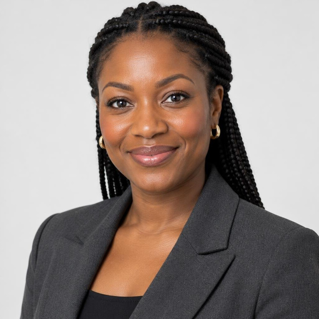 Portrait of a Black British woman with braided hair smiling